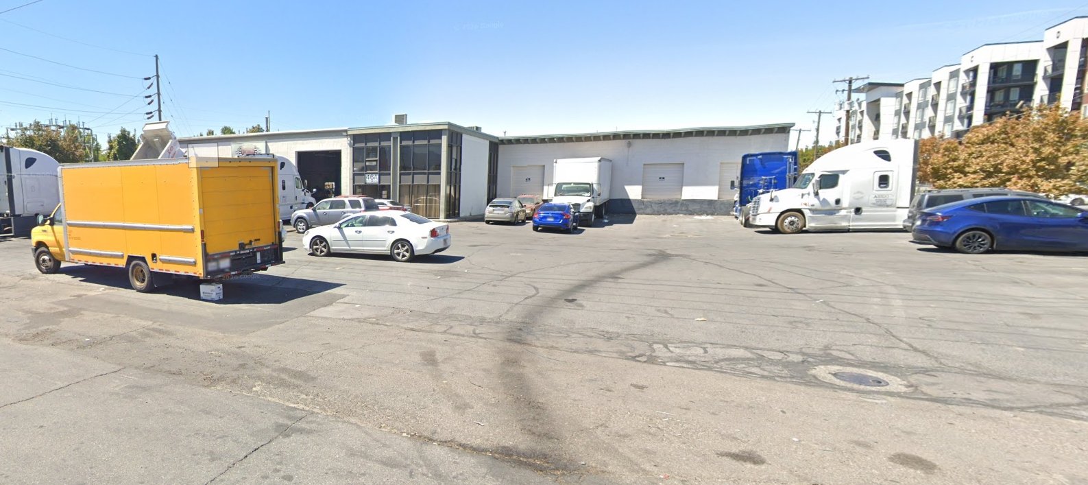 Pickup gate — the four white roll-up doors on the building